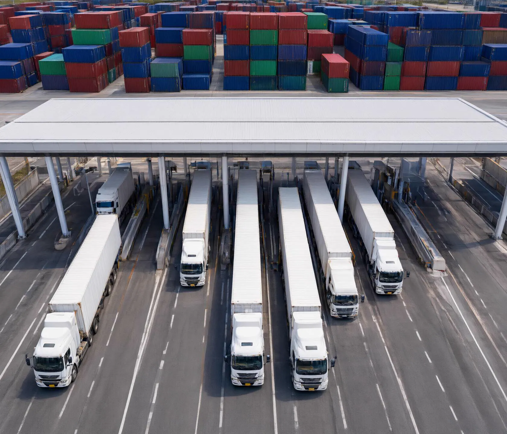 Trucks move through a port gate.